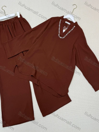 Wholesale Two-piece set: chain-trim V-neck top + wide-leg pants. Soft, breathable fabric and a relaxed fit for comfort and style